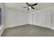 Bedroom featuring neutral carpet, ceiling fan, and double sliding closet doors at 1676 Divinity St, Las Vegas, NV 89142