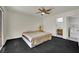 Cozy bedroom featuring a ceiling fan and adjoining bathroom and laundry room at 1676 Divinity St, Las Vegas, NV 89142