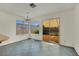 Dining area features tile floors, large window overlooking the yard, and modern lighting at 1676 Divinity St, Las Vegas, NV 89142