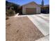 Charming single-story home features a two-car garage and low-maintenance desert landscaping at 1676 Divinity St, Las Vegas, NV 89142