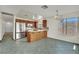 Bright kitchen features stainless steel appliances, mosaic backsplash and wood cabinets and breakfast bar at 1676 Divinity St, Las Vegas, NV 89142