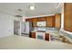 Kitchen area boasts stainless steel appliances, wood cabinets, and a tiled backsplash at 1676 Divinity St, Las Vegas, NV 89142