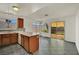 Open kitchen with tile floors, wood cabinets, mosaic backsplash and a breakfast bar overlooking the yard at 1676 Divinity St, Las Vegas, NV 89142