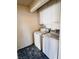 Efficient laundry room with washer, dryer, and storage cabinets at 1676 Divinity St, Las Vegas, NV 89142