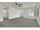 Bright living room with neutral carpet and a large window providing natural light at 1676 Divinity St, Las Vegas, NV 89142