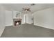 Inviting living room with neutral carpet, cozy fireplace, and a classic ceiling fan at 1676 Divinity St, Las Vegas, NV 89142