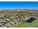 Expansive aerial image displaying a suburban area with residential properties, landscaping, and a tranquil pond at 19 Contrada Fiore Dr, Henderson, NV 89011