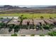 High-angle shot capturing residences with well-kept landscaping, solar panels, and tile roofs on a residential street at 19 Contrada Fiore Dr, Henderson, NV 89011