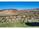 Expansive desert community showcasing beautiful homes, a tranquil pond, and picturesque mountain views at 19 Contrada Fiore Dr, Henderson, NV 89011