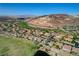Breathtaking aerial view of a community with backyard pools, a golf course, and desert landscape at 19 Contrada Fiore Dr, Henderson, NV 89011
