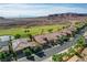 Elevated view of residential street showing desert landscaping and homes with solar panels and tile roofs at 19 Contrada Fiore Dr, Henderson, NV 89011