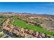 Panoramic aerial view of a golf course community featuring lush green fairways and well-maintained homes at 19 Contrada Fiore Dr, Henderson, NV 89011