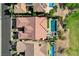 An aerial view of a home with a tile roof, a pool, desert landscaping, and a paver driveway at 19 Contrada Fiore Dr, Henderson, NV 89011