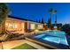 Beautiful backyard featuring a sparkling pool, spa, and covered patio area at 19 Contrada Fiore Dr, Henderson, NV 89011
