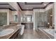 Luxurious bathroom featuring dual sinks, a soaking tub, and a separate glass-enclosed shower at 19 Contrada Fiore Dr, Henderson, NV 89011