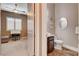 View from bedroom of a small bathroom that features a toilet and a vanity with storage at 19 Contrada Fiore Dr, Henderson, NV 89011