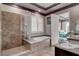 Primary bathroom features a soaking tub, a tile and glass shower, and a double vanity at 19 Contrada Fiore Dr, Henderson, NV 89011