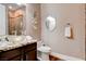 Bathroom with a glass bowl sink, unique tiling, decorative elements, and granite countertop at 19 Contrada Fiore Dr, Henderson, NV 89011