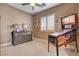 Comfortable bedroom with ceiling fan, neutral walls and decor, and unique pinball machine at 19 Contrada Fiore Dr, Henderson, NV 89011