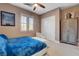 Relaxing bedroom showcasing nautical decor, white seating, and closet at 19 Contrada Fiore Dr, Henderson, NV 89011