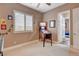 Cozy bedroom with large window, plantation shutters, and a fun pinball machine at 19 Contrada Fiore Dr, Henderson, NV 89011