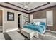 This stylish bedroom features a tray ceiling, decorative wall accents, and a luxurious bed and headboard at 19 Contrada Fiore Dr, Henderson, NV 89011