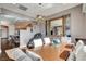 Open dining room with wood floors, stylish lighting, and adjacent kitchen view at 19 Contrada Fiore Dr, Henderson, NV 89011