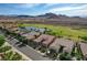 Beautiful single-story home with a well-manicured front yard, lush greenery and desert views at 19 Contrada Fiore Dr, Henderson, NV 89011