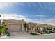 Charming single-story home with a well-manicured lawn, desert landscaping, and a spacious two-car garage at 19 Contrada Fiore Dr, Henderson, NV 89011