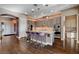 Contemporary kitchen featuring dark wood floors, granite countertops, an island, and stainless appliances at 19 Contrada Fiore Dr, Henderson, NV 89011