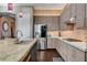 Granite countertops, stainless steel appliances, mosaic backsplash, and wood cabinets in a modern kitchen at 19 Contrada Fiore Dr, Henderson, NV 89011