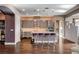 Modern kitchen with island, pendant lighting, stainless steel appliances, and mosaic backsplash at 19 Contrada Fiore Dr, Henderson, NV 89011