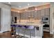 Modern kitchen with pendant lights, stainless steel appliances, and mosaic backsplash detail at 19 Contrada Fiore Dr, Henderson, NV 89011