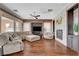 Spacious living room featuring hardwood floors, comfortable seating, and a modern fireplace at 19 Contrada Fiore Dr, Henderson, NV 89011