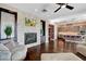 Open-concept living space boasts a stone fireplace and hardwood floors at 19 Contrada Fiore Dr, Henderson, NV 89011