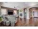 Open concept living area with fireplace, hardwood floors, and comfortable seating at 19 Contrada Fiore Dr, Henderson, NV 89011