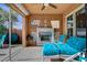 Relaxing outdoor patio with a fireplace, comfortable seating, and views of the backyard at 19 Contrada Fiore Dr, Henderson, NV 89011
