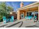 Covered patio featuring a stone fireplace and great views of the mountains at 19 Contrada Fiore Dr, Henderson, NV 89011