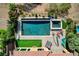 Aerial view of backyard oasis with pool, spa, putting green, and patio furniture at 19 Contrada Fiore Dr, Henderson, NV 89011