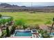 Home features a pool, spa, patio, desert landscaping, and view of golf course at 19 Contrada Fiore Dr, Henderson, NV 89011