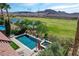 Home features a pool, spa, patio, desert landscaping, view of lake and golf course at 19 Contrada Fiore Dr, Henderson, NV 89011
