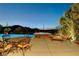 Inviting pool and spa area complete with lounge chairs, and outdoor dining set at 19 Contrada Fiore Dr, Henderson, NV 89011