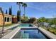 Inviting outdoor living space featuring a refreshing pool and spa with lush landscaping at 19 Contrada Fiore Dr, Henderson, NV 89011