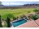 Home features a pool, spa, patio, desert landscaping, and view of golf course at 19 Contrada Fiore Dr, Henderson, NV 89011
