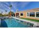 Backyard pool featuring manicured lawn, patio seating, and an open-air patio room at 19 Contrada Fiore Dr, Henderson, NV 89011