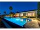 Inviting outdoor pool and backyard with ample space and lighting at dusk at 19 Contrada Fiore Dr, Henderson, NV 89011