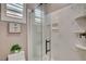 Bathroom featuring glass enclosed shower, with marble walls and built-in shelving at 19 Contrada Fiore Dr, Henderson, NV 89011