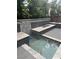 Backyard showcasing a water feature and tiled sitting area, enhanced by decorative black rocks at 2090 Morro Vista Dr, Las Vegas, NV 89135