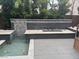 Backyard featuring a water feature, tiled sitting area, green foliage, and a playhouse on the right at 2090 Morro Vista Dr, Las Vegas, NV 89135