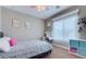 Cozy bedroom with a bed, desk, storage units and a window providing natural light at 2090 Morro Vista Dr, Las Vegas, NV 89135